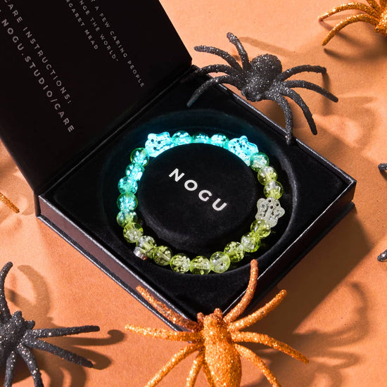 Garden Spectre silver Firefly Glass ghost bead bracelet glowing in black NOGU box with Halloween decorations